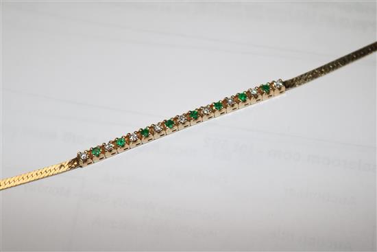 A 14ct gold, emerald and diamond small line bracelet, 15cm.